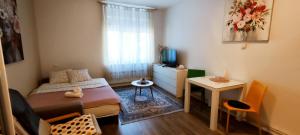 a small bedroom with a bed and a small table at Studio Cibona in Zagreb