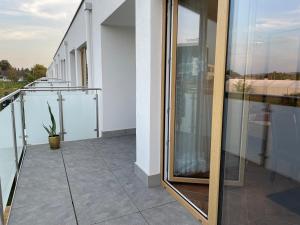 a balcony with glass doors on a building at Lux Apartment in Rzeszów