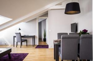 a living room with a dining room table and chairs at Frogner House - Bogstadveien in Oslo