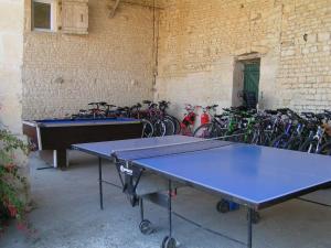 two ping pong tables in a room with bikes at 8 Gite Complex, 53 People maximum , Marriage, Birthdays, family get togethers in Doeuil-sur-le-Mignon