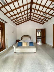 a bedroom with a bed with blue pillows at Rumah di Patra Kuningan, Jaksel in Jakarta