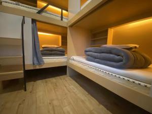 two bunk beds in a room with blue towels at Chengdong Yishu Inn Youth Hostel in Hangzhou