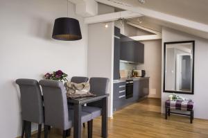 a dining room with a table and chairs and a kitchen at Frogner House - Bogstadveien in Oslo