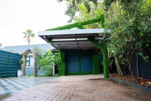 a house with a garage and a brick driveway at G&D Guesthouse in Cape Town