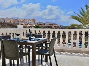 a table and chairs on a balcony with a view at Playa Ajabo Beachfront Apartment in Callao Salvaje