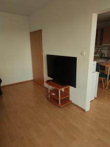 a flat screen tv sitting on a stand in a living room at Apartmán blízko centra Levice in Levice