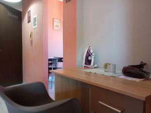 a waiting room with a chair at a counter at Cozy studio flat 1 bedroom-Very central location in Mytilene