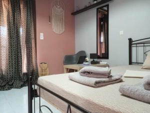 a bedroom with two beds and a desk at Cozy studio flat 1 bedroom-Very central location in Mytilene