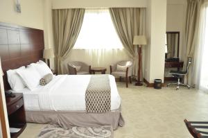 a hotel room with a bed and a large window at Addissinia Hotel in Addis Ababa