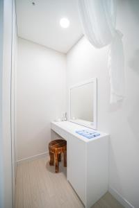 a bathroom with a white sink and a mirror at Mild in Daejeon