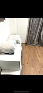 a white bed in a room with a wooden floor at 3 Bed Luxury High End Apartment 5 min walk to Oktoberfest in Munich