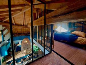 a bedroom with a bed and a large glass window at La Réserve Taïno in Arjuzanx +117 photos