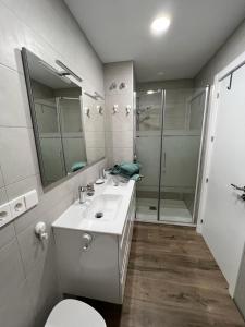 a bathroom with a toilet and a sink and a shower at SAN MIGUEL PLAYA ALMERIA in Almería