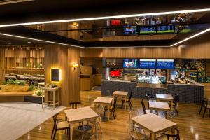 a restaurant with tables and chairs and a counter at Shinjuku Prince Hotel in Tokyo