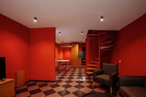 a living room with red walls and a checkered floor at Urban Apartments 23 in Tbilisi City