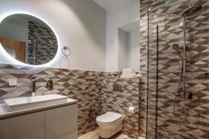 a bathroom with a shower and a toilet and a sink at Urban Apartments 23 in Tbilisi City +12 photos