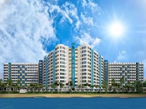 a large apartment building on the beach with the ocean at Signature Mutiara Beach Resort by Glex in Melaka