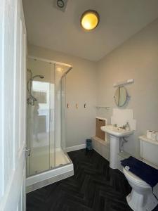 a bathroom with a shower and a toilet and a sink at Portland Outdoor Centre Hostel in Portland