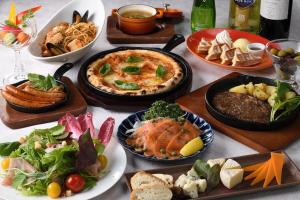 a table topped with plates of food and bowls of food at Shinjuku Prince Hotel in Tokyo