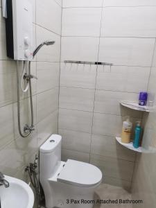 a bathroom with a toilet and a sink at Mersing Maple Villa in Mersing