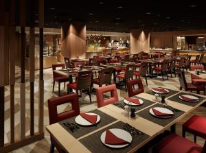 a restaurant with tables and chairs and a bar at Shinjuku Prince Hotel in Tokyo