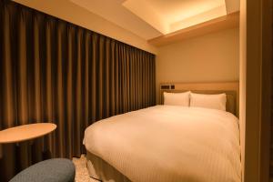 Postel nebo postele na pokoji v ubytování Hotel Emion Sapporo