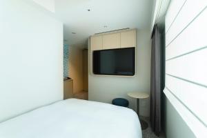 Postel nebo postele na pokoji v ubytování Hotel Emion Sapporo