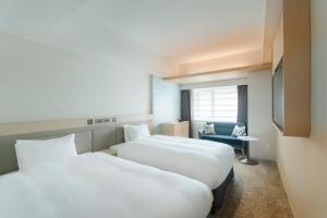 Postel nebo postele na pokoji v ubytování Hotel Emion Sapporo