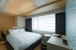 Postel nebo postele na pokoji v ubytování Hotel Emion Sapporo