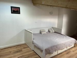 a bed with two pillows on it in a room at Clos La Vigne in Cornas