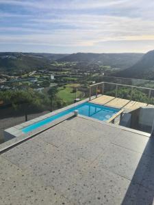 a swimming pool on the roof of a house at Sunset Cove in Plettenberg Bay