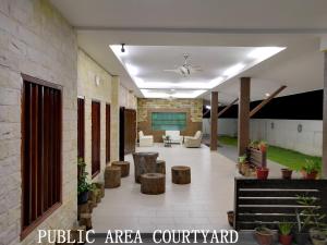 a lobby of a building with couches and tables at Mersing Maple Villa in Mersing