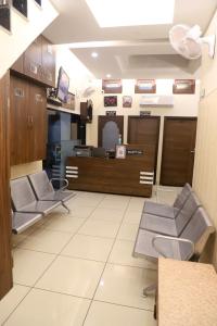 a waiting room at a hospital with chairs and tables at Rk Lodge in Amritsar