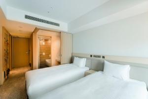 Postel nebo postele na pokoji v ubytování Hotel Emion Sapporo