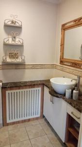 a bathroom with a sink and a mirror at Luxurious West Cork holiday home in Bantry