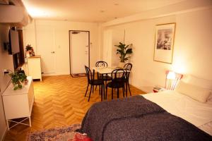 a room with a bed and a table and chairs at #5 3stops to Shinjuku station stylish spacious studio apartment in Tokyo