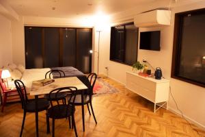 a room with a table and a bed and a bedroom at #5 3stops to Shinjuku station stylish spacious studio apartment in Tokyo