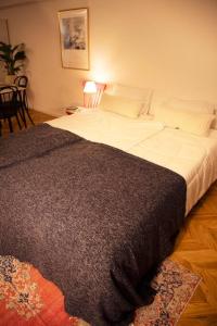 a bedroom with a large bed with a black blanket at #5 3stops to Shinjuku station stylish spacious studio apartment in Tokyo