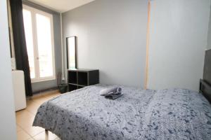 a bedroom with a bed with a phone on it at 02 - Chambre avec lit double et sdb privé Wifi in Saint-Denis