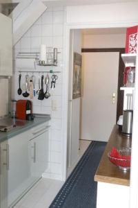 a kitchen with white cabinets and a counter top at Ferienwohnung mit Pfiff in Siegsdorf