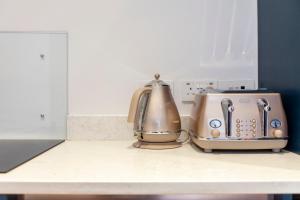 two toasters sitting on top of a kitchen counter at Bright King's Cross 2 bedroom flat with patio in London
