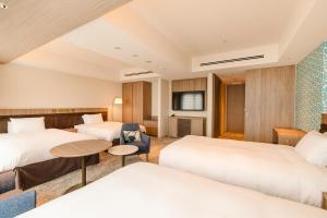 Postel nebo postele na pokoji v ubytování Hotel Emion Sapporo