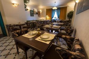 a restaurant with tables and chairs in a room at Hotel Westermann in Oelde