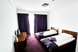 Uma cama ou camas num quarto em Hotel Eden