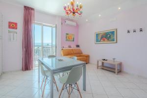a living room with a table and chairs and a couch at A Casa Mia in Floridia
