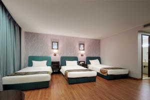 Voodi või voodid majutusasutuse Foshan Guanxin Hotel toas