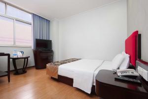 Voodi või voodid majutusasutuse Foshan Guanxin Hotel toas