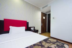 Voodi või voodid majutusasutuse Foshan Guanxin Hotel toas