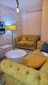 ein Wohnzimmer mit 2 Sofas und einem TV in der Unterkunft Shamir trm studio in Nairobi