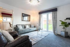 a living room with a couch and a table at Beautifully designed 3 Bed House - in Manchester in Manchester